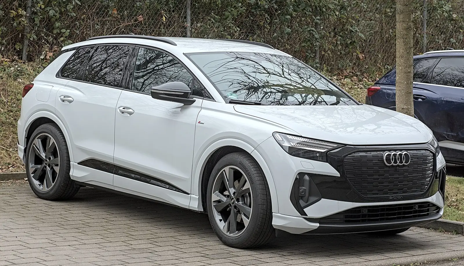 White Audi Q4 e-tron electric SUV parked outdoors, an EV option at Santa Monica's Audi store
