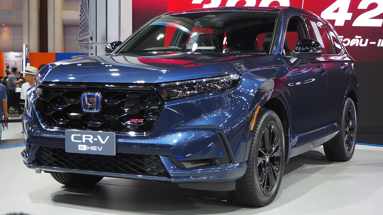 Blue Honda CR-V hybrid compact SUV, front three-quarter view, a common family car in Long Beach
