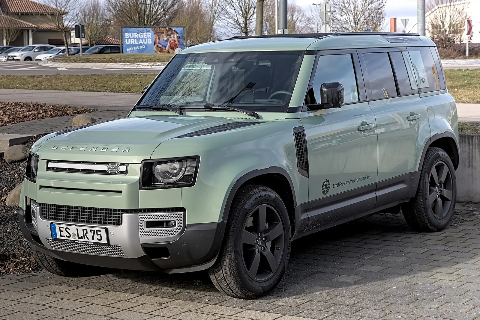 Pale green Land Rover Defender 110 SUV parked outdoors, a capable pick for Malibu canyon roads