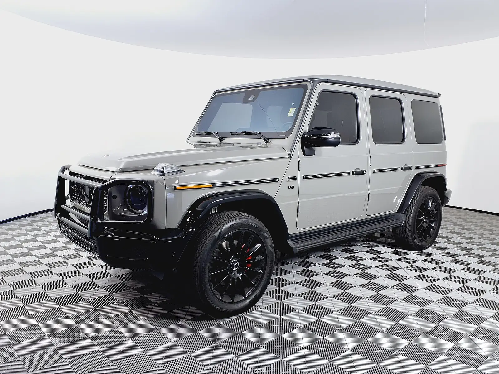 Silver Mercedes-Benz G550 4MATIC SUV in a showroom, a classic Malibu luxury SUV