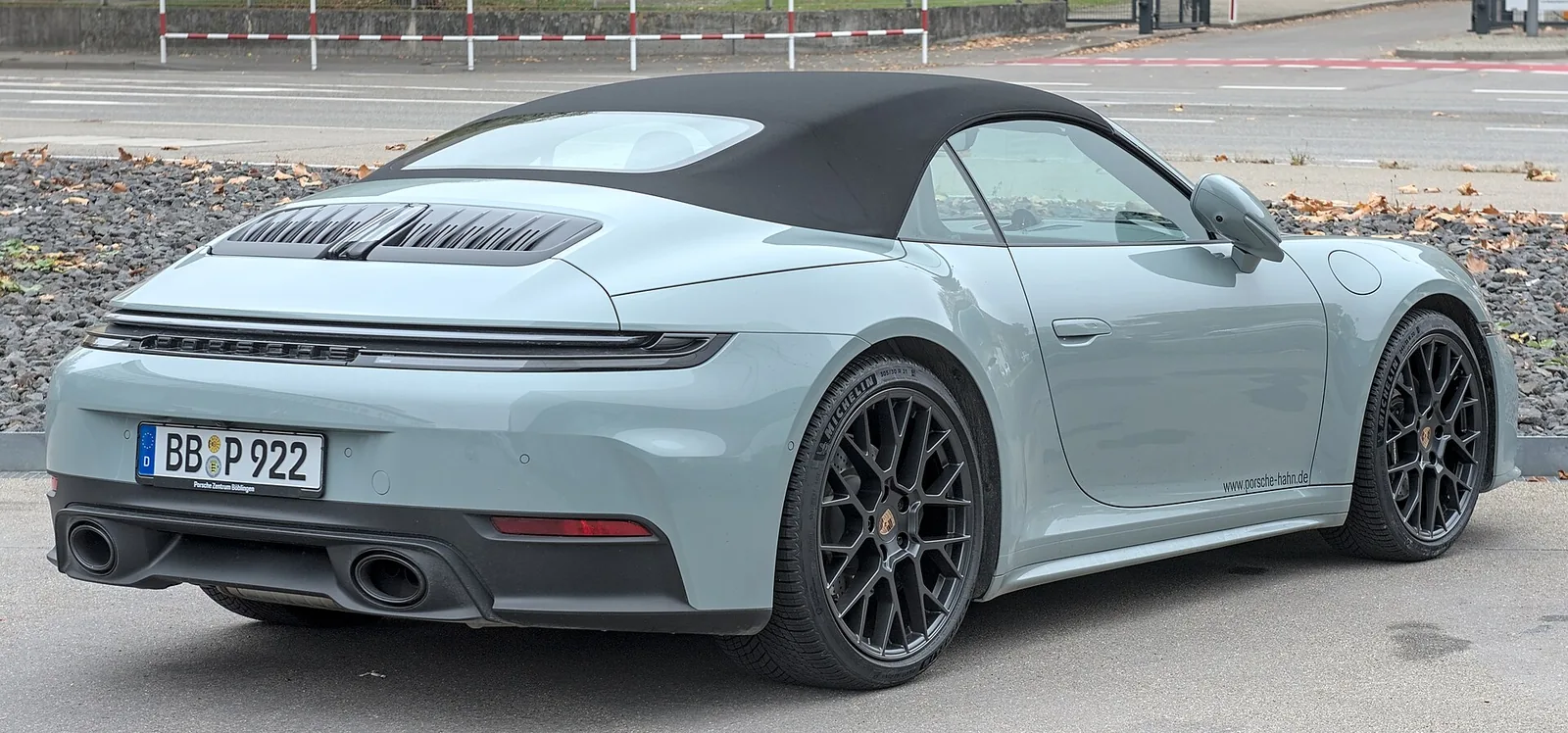 Light blue Porsche 911 Carrera Cabriolet with the top up, side profile