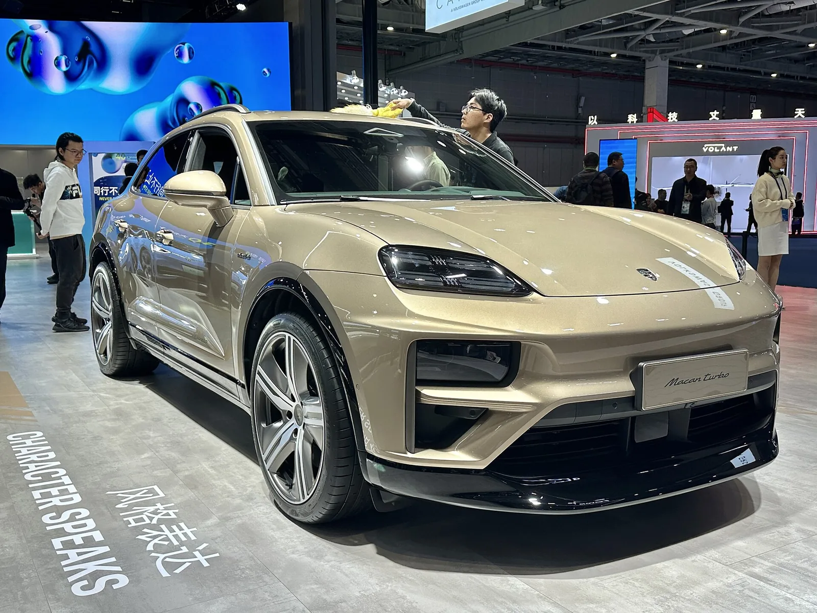 Porsche Macan Turbo Electric SUV in a champagne color on display, an EV many South Bay buyers ask about