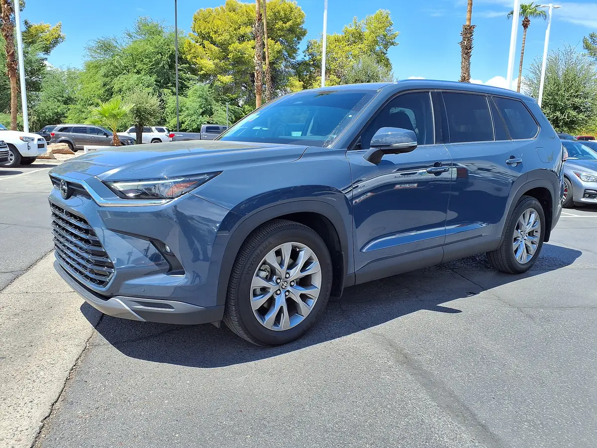 Blue Toyota Grand Highlander three-row family SUV parked in a sunny lot